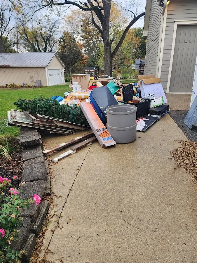 Dumpster being loaded with debris for Estate Cleanout Dumpster Rental in Robins